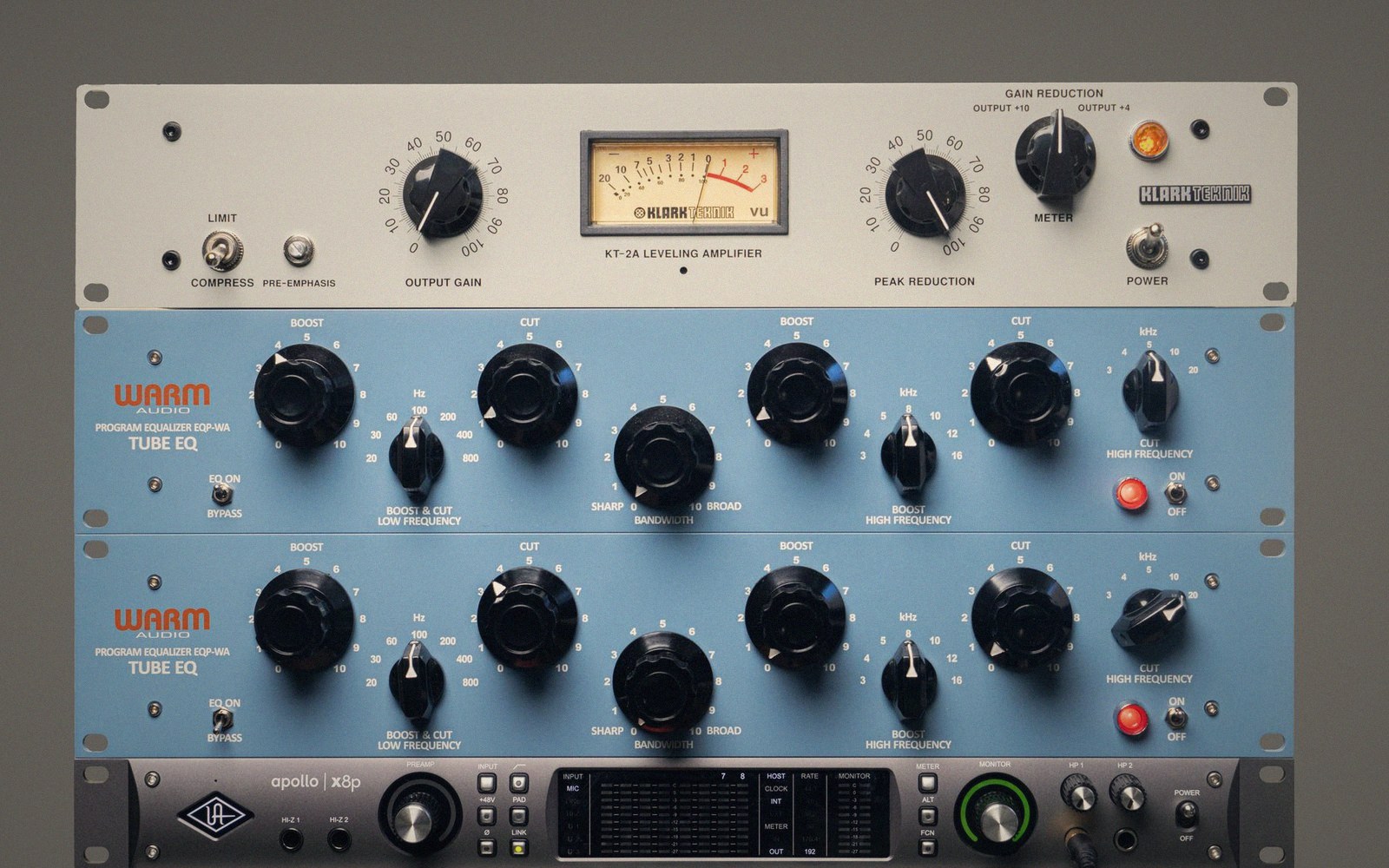 Rack-mounted studio gear including a Klark Teknik leveling amplifier and two Warm Audio tube EQs